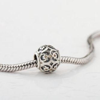 Silver charm bead with ornament for chain bracelet. Product concept for jeweler