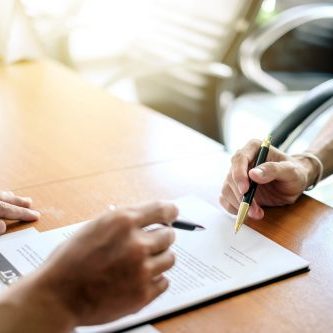 Man signing a contract. Signing an agreement in a document