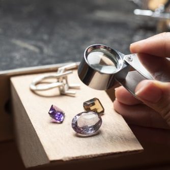 Jewellery equipment and semi-precious gem on the workbench.