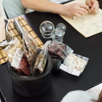 Close up photo of acupuncturist examining woman patient. Alternative Medicine