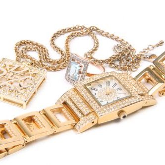 Jewelry set. Golden watch, ring and necklace.