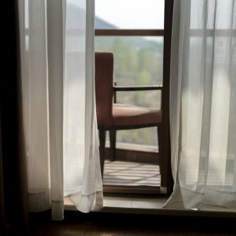 chair on balcony in sunlight