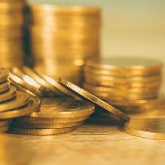 Columns of gold coins, piles of coins on working table, business banking and financial concept idea.